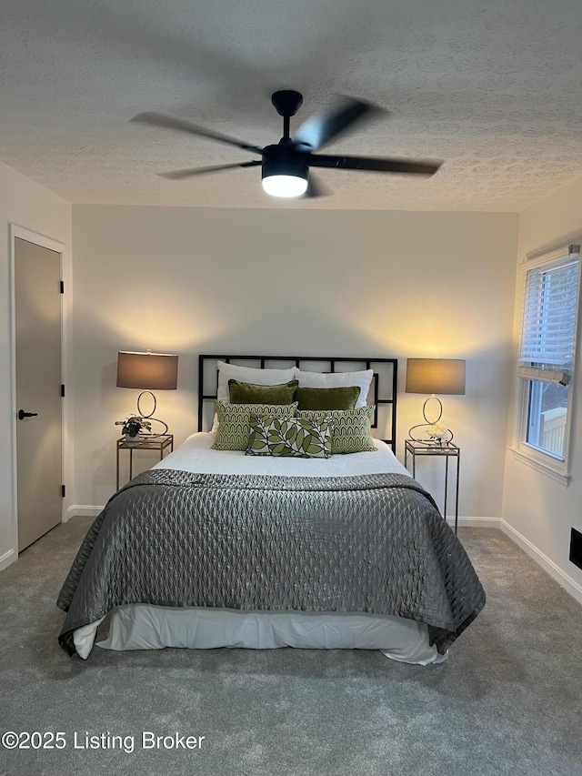 bedroom with a ceiling fan, baseboards, carpet floors, and a textured ceiling