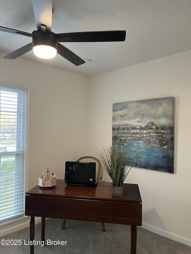 carpeted office featuring a textured ceiling, baseboards, and ceiling fan