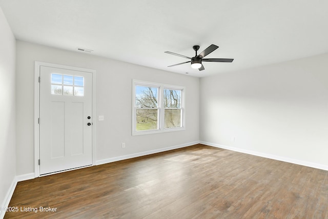 foyer entrance with visible vents, baseboards, wood finished floors, and a ceiling fan