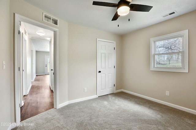 unfurnished bedroom with baseboards, visible vents, and carpet floors