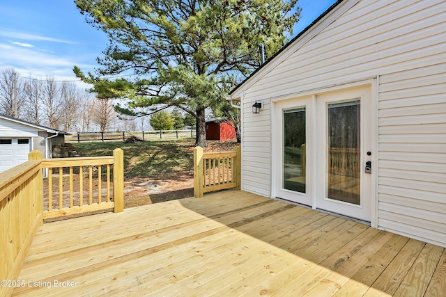 deck with an outbuilding and fence