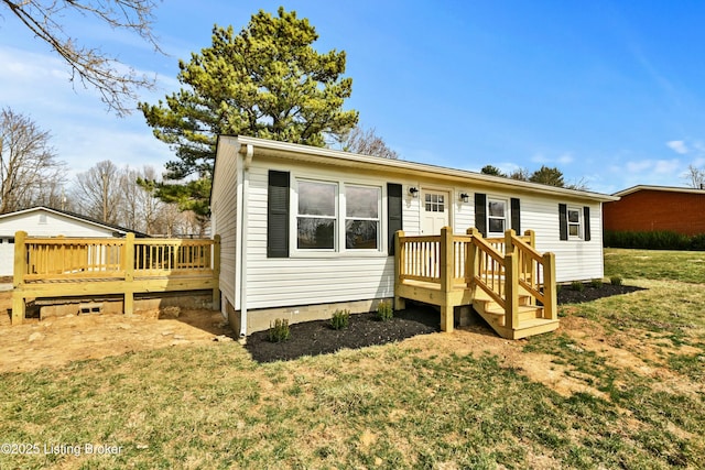 back of house featuring a deck, a lawn, and crawl space