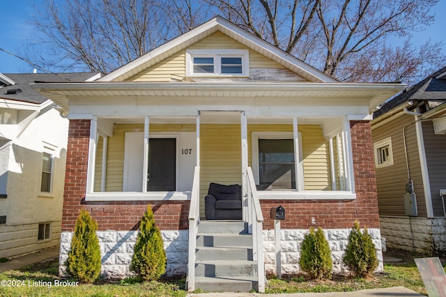 bungalow-style house with brick siding and a porch