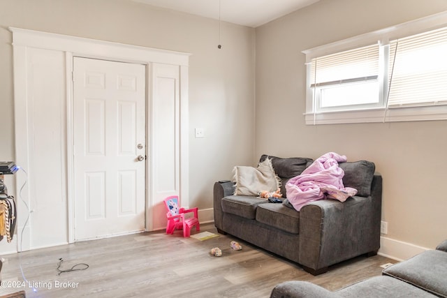 living area featuring baseboards and wood finished floors