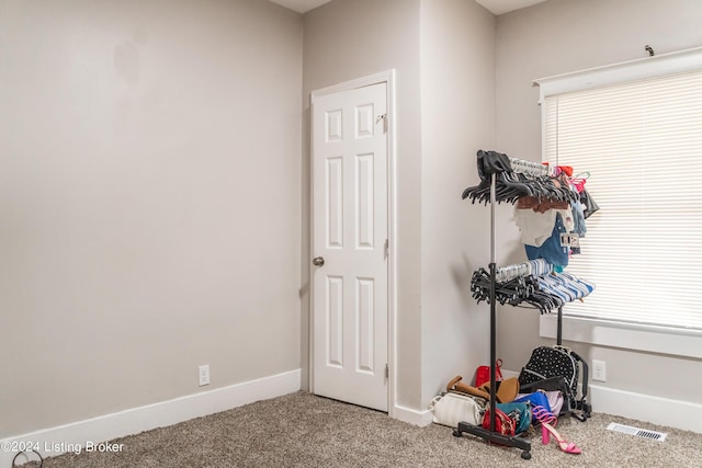 interior space featuring visible vents, baseboards, and carpet