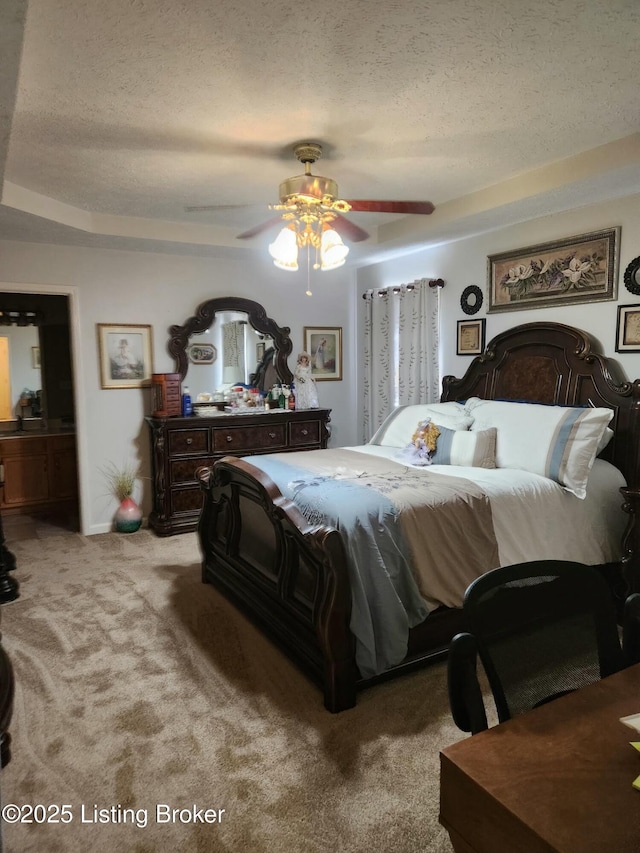 bedroom featuring light carpet, a textured ceiling, and ceiling fan