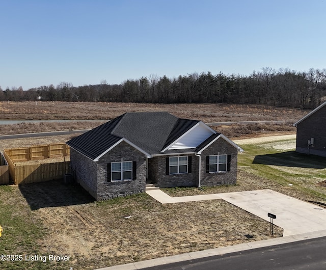 view of front of home featuring crawl space, brick siding, and fence