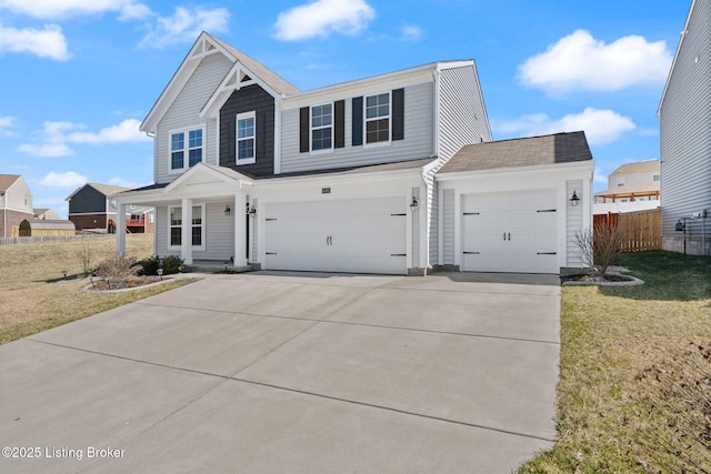 view of front of home with a garage, driveway, a front yard, and fence