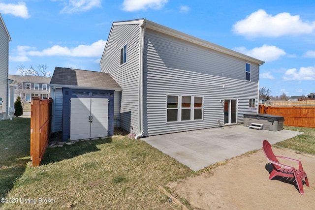 back of property with a patio, fence, a yard, an outdoor structure, and a storage shed