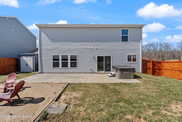 rear view of house featuring a patio, a yard, a fenced backyard, and an outdoor structure