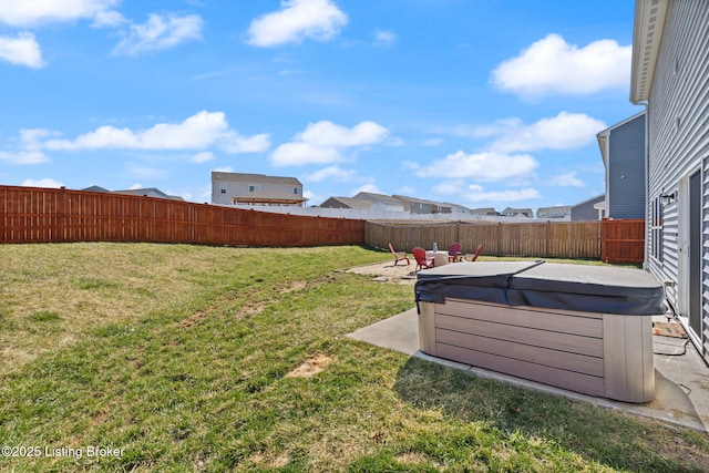 view of yard featuring a patio, a fenced backyard, and a hot tub