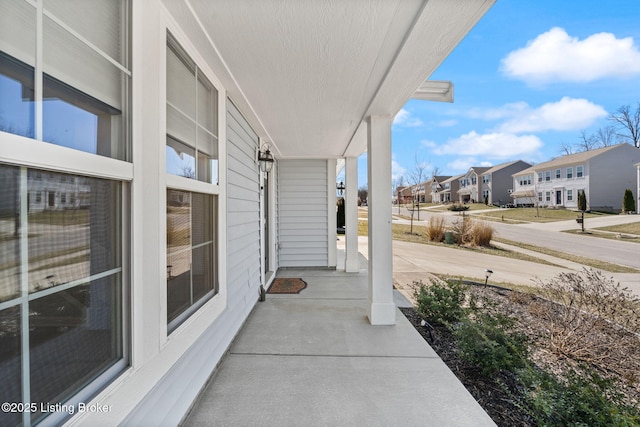 view of patio / terrace with a porch and a residential view