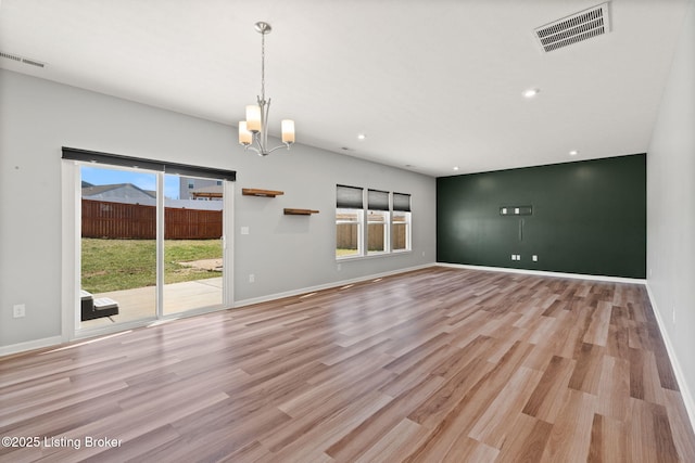 spare room with plenty of natural light, visible vents, and light wood-type flooring