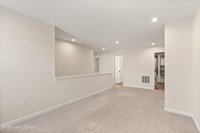 unfurnished room featuring visible vents, recessed lighting, baseboards, and carpet