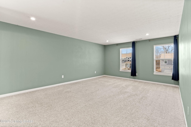 empty room featuring recessed lighting, baseboards, and carpet floors