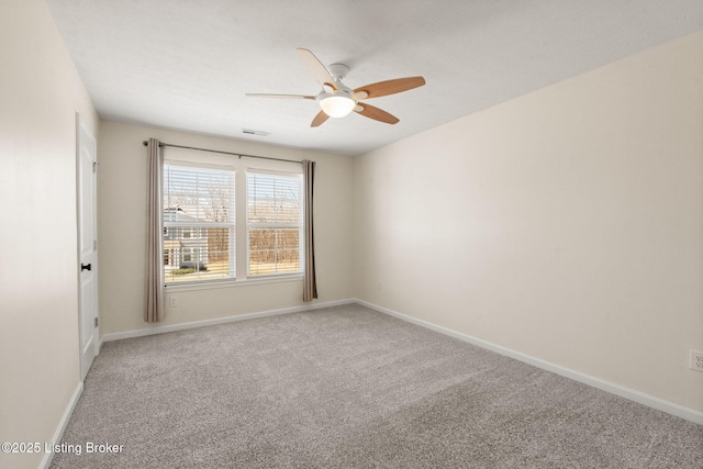 carpeted empty room with a ceiling fan, baseboards, and visible vents