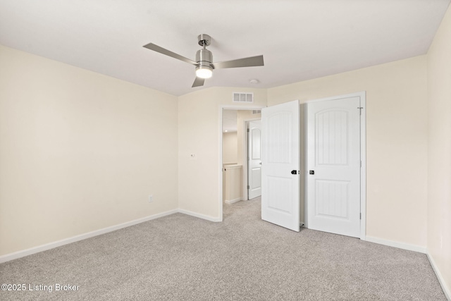 unfurnished bedroom with visible vents, light colored carpet, and baseboards