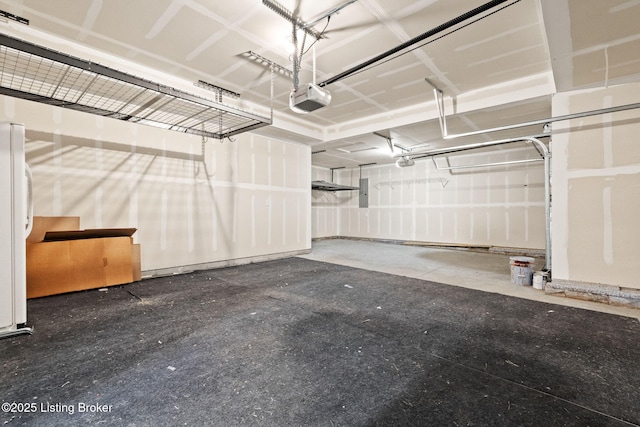 parking deck with electric panel, a garage door opener, and freestanding refrigerator