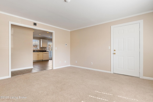 unfurnished living room featuring tile patterned floors, baseboards, carpet flooring, and crown molding