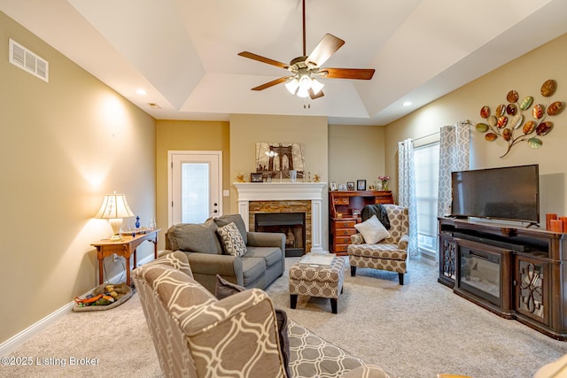 carpeted living room featuring visible vents, ceiling fan, baseboards, recessed lighting, and a fireplace