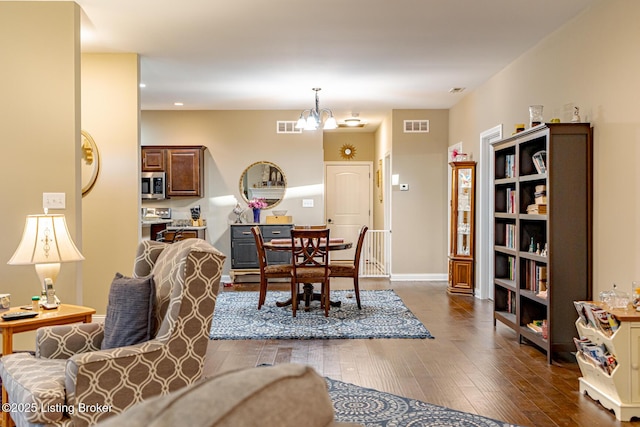 dining room featuring recessed lighting, dark wood-style floors, visible vents, and a chandelier