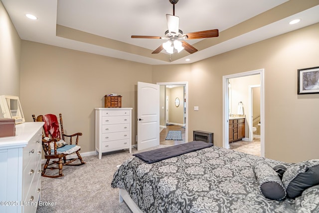 bedroom with recessed lighting, baseboards, light carpet, and connected bathroom