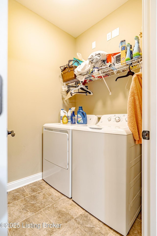 washroom featuring baseboards, independent washer and dryer, and laundry area