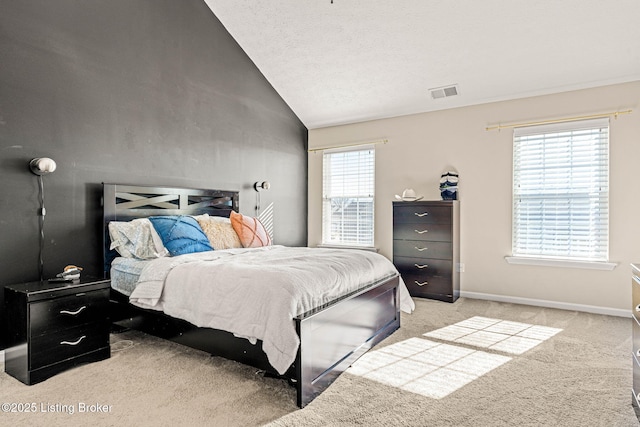 carpeted bedroom featuring visible vents, baseboards, and lofted ceiling