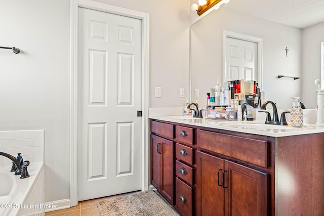 bathroom with tile patterned flooring, double vanity, a tub to relax in, and a sink