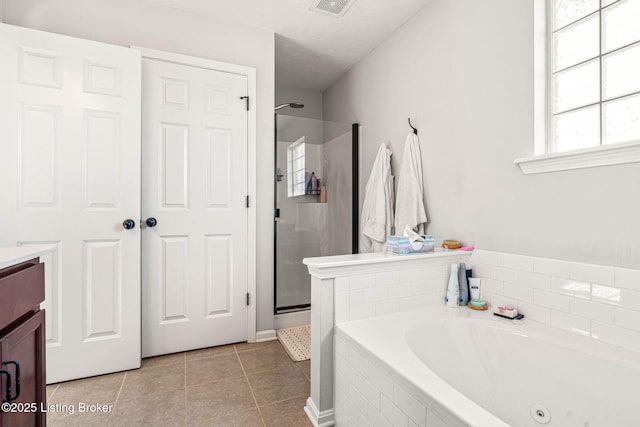 bathroom with visible vents, a jetted tub, a stall shower, tile patterned floors, and vanity