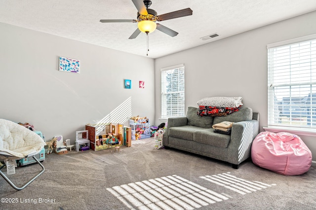 playroom with visible vents, plenty of natural light, and a textured ceiling