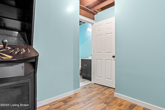 interior space featuring wood finished floors and baseboards