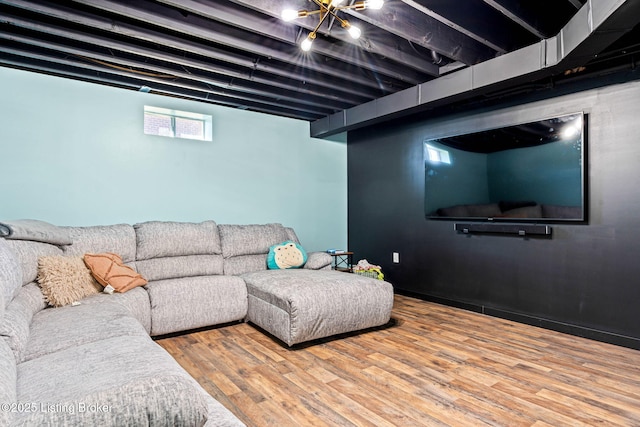 living area with baseboards and wood finished floors