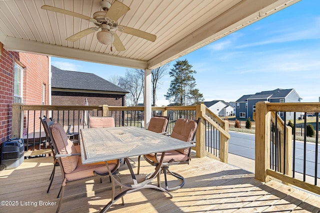 deck with outdoor dining area and ceiling fan