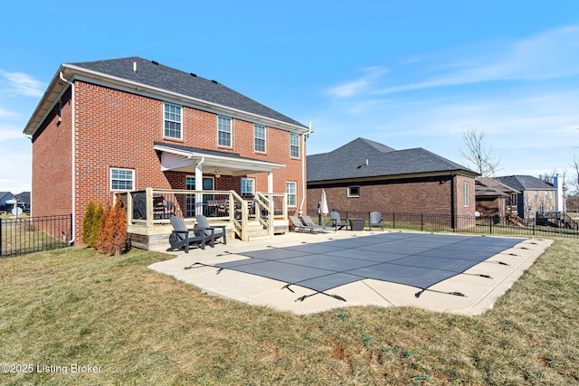 view of pool featuring a lawn, a fenced backyard, a wooden deck, a fenced in pool, and a patio area