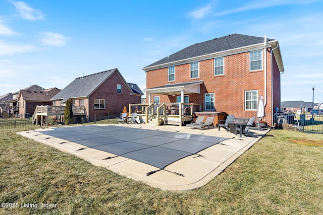 view of swimming pool featuring a jacuzzi, a patio, a fenced backyard, a yard, and a fenced in pool