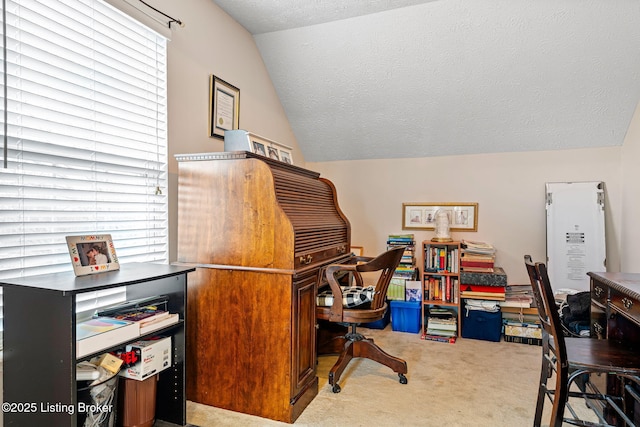 home office featuring plenty of natural light, a textured ceiling, lofted ceiling, and carpet floors