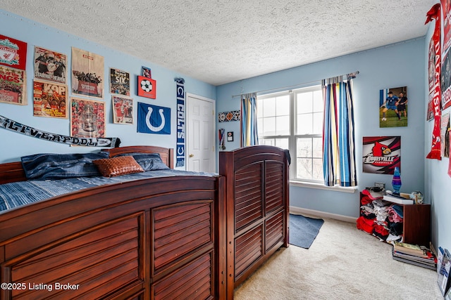 carpeted bedroom featuring baseboards and a textured ceiling