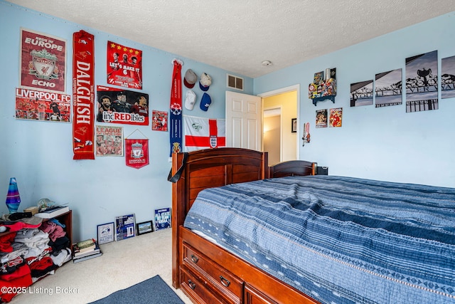 carpeted bedroom featuring visible vents and a textured ceiling