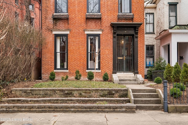 view of exterior entry with brick siding