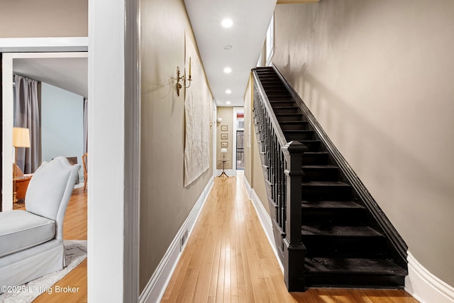 stairway with recessed lighting, baseboards, and wood-type flooring