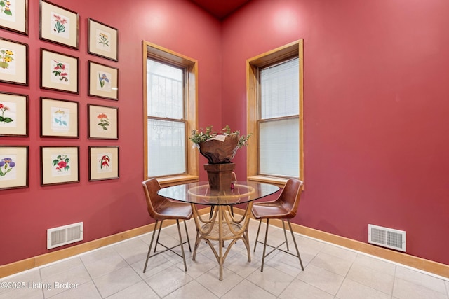 dining area featuring tile patterned flooring, visible vents, and baseboards