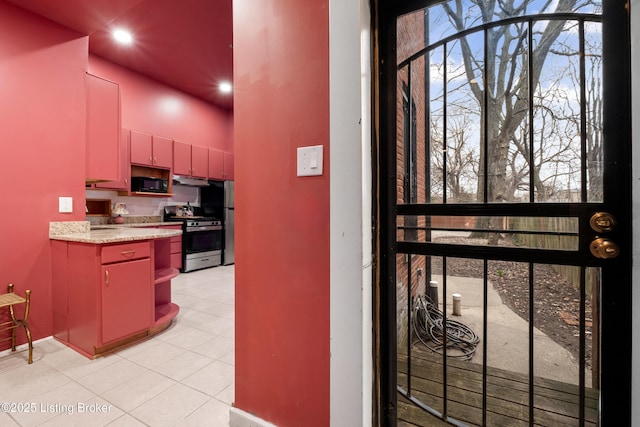 kitchen featuring open shelves, red cabinets, appliances with stainless steel finishes, light countertops, and a towering ceiling