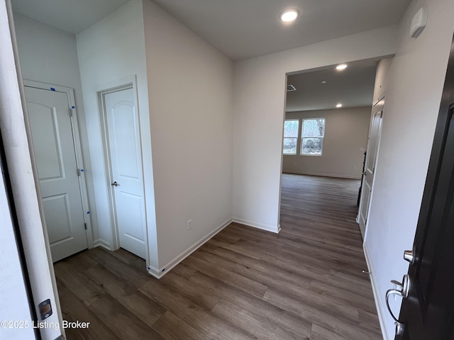 corridor with recessed lighting, baseboards, and dark wood-style flooring