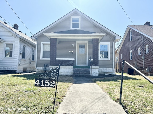 bungalow-style home featuring a front yard