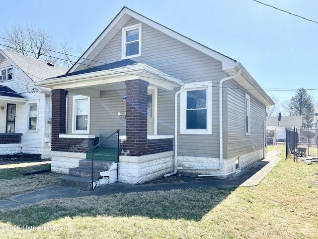 bungalow with a porch and a front yard