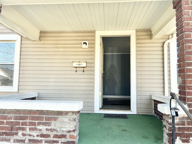 property entrance with brick siding