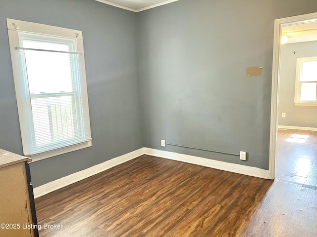 unfurnished room with dark wood-type flooring and baseboards