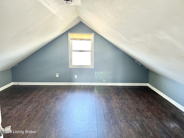 bonus room featuring baseboards, wood finished floors, and vaulted ceiling