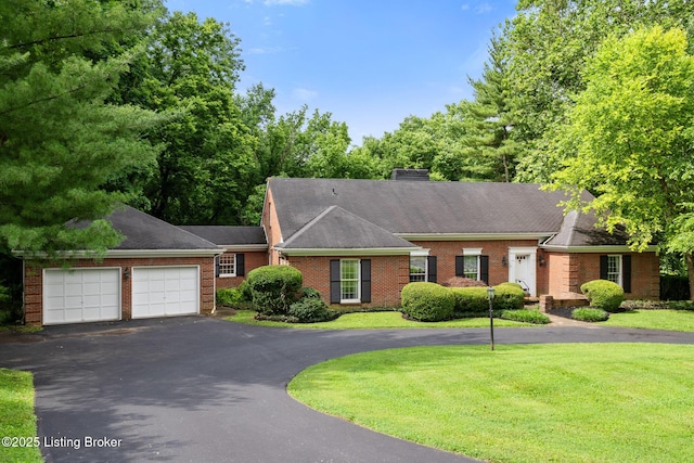 602 Club Ln, Louisville, KY 40207 - view of front of property with driveway, an attached garage, brick siding, and a front lawn